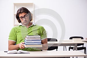 Young male student in the classroom