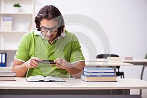 Young male student in the classroom