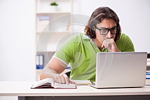 Young male student in the classroom