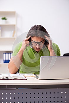 Young male student in the classroom