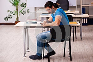 Young male student in the classroom