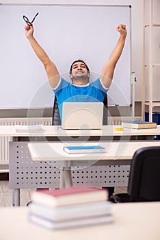 Young male student in the classroom