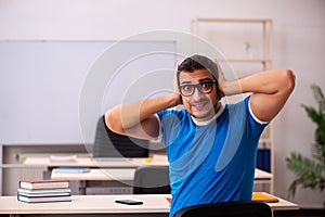 Young male student in the classroom