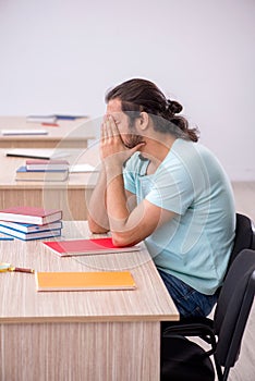 Young male student in the classroom during pandemic