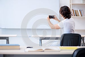 Young male student in front of whiteboard