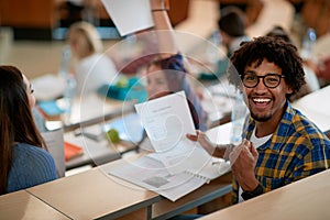 Young male student happy about his scores of the exam photo