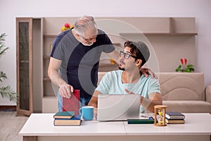 Young male student and his grandfather at home