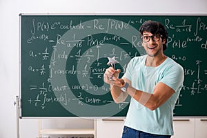 The young male student mathematician in front of chalkboard