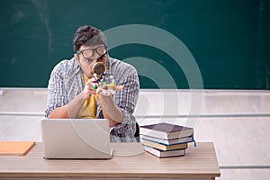 Young male student physicist sitting in the classroom