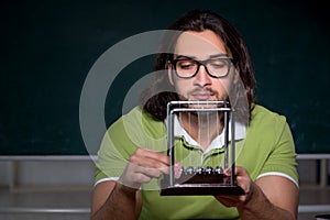 Young male student physicist working hard at night time