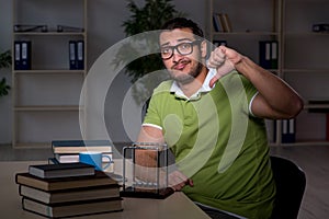 Young male student physicist working hard at night time