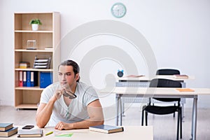 Young male student preparing for exam in the classroom