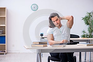 Young male student preparing for exam in the classroom