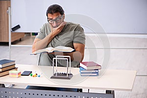 Young male student preparing for exams in the classroom