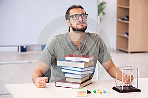 Young male student preparing for exams in the classroom