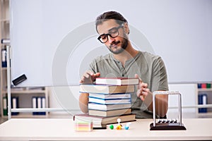 Young male student preparing for exams in the classroom