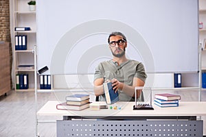 Young male student preparing for exams in the classroom