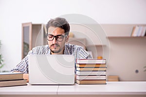 Young male student preparing for exams at home