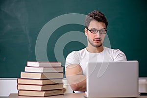 Young male student sitting in the classroom