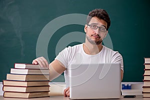 Young male student sitting in the classroom