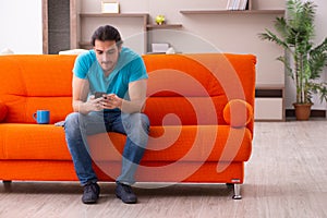 Young male student sitting indoors during pandemic