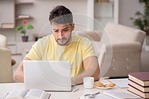 Young male student studying at home