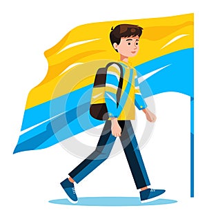 Young male student walking with a large blue and yellow flag behind him. Casual teenager with backpack strolling