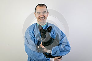 Young male surgeon stand veterinarian hold dog smile cute