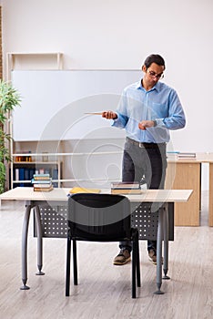 Young male teacher in the classroom