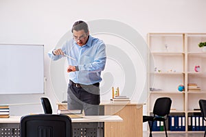 Young male teacher in the classroom