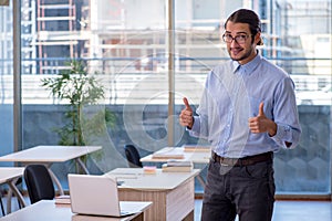 Young male teacher in the classroom