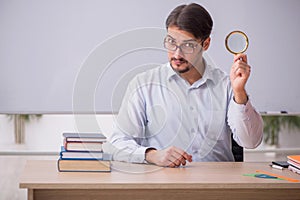 Young male teacher in front of whiteboard