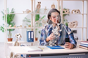 Young male teacher paleontologist in the classroom