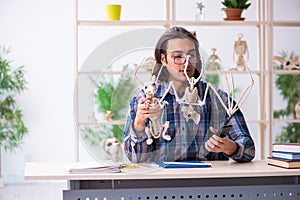 Young male teacher paleontologist in the classroom