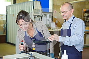 Young male technician in blue overall in metalworks workshop