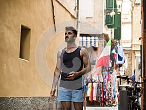 Young male tourist exploring old italian town