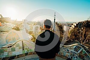 Young male tourist spending vacation in Barcelona,Spain.Traveling to Europe,visiting Parc Guell UNESCO site famous historical