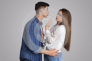 Young male tries to kiss upset lady, woman does not like molestation and does not want harassment photo