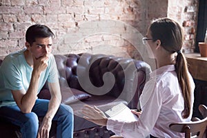 Young male visiting psychologist therapist counselor, doctor