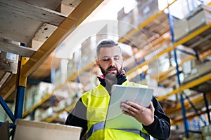Male warehouse worker with tablet. photo