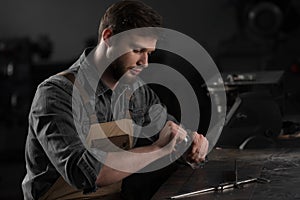 young male worker opening bottle of water and sitting photo