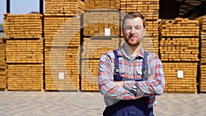 Young male worker in timber lumber warehouse