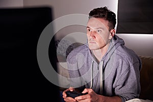 Young Man Addicted To Video Gaming At Home