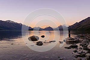 Young man admiring the beuaty in Lake Wakatipu sunset. New Zealand, South Island