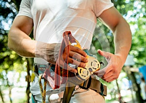 Young man in adventure rope park. Climbing Equipment.