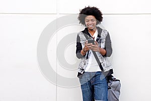 Young man with afro looking at cell phone