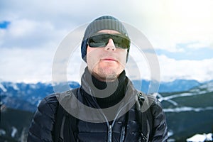 Young man against panorama of mountains