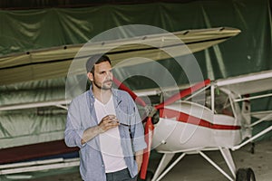 Young man in the airplane hangar