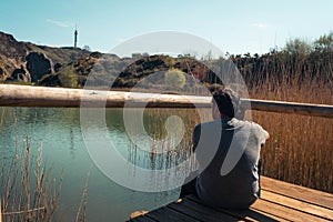 A young man alone on a lake, portrait, la arboleda, basque country