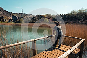 A young man alone on a lake, portrait, la arboleda, basque country